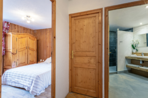 An image of the bedroom and bathroom in a privately owned apartment for skiing in Val d'Isere