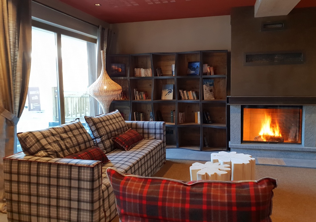 An image of the lounge with cosy fireplace