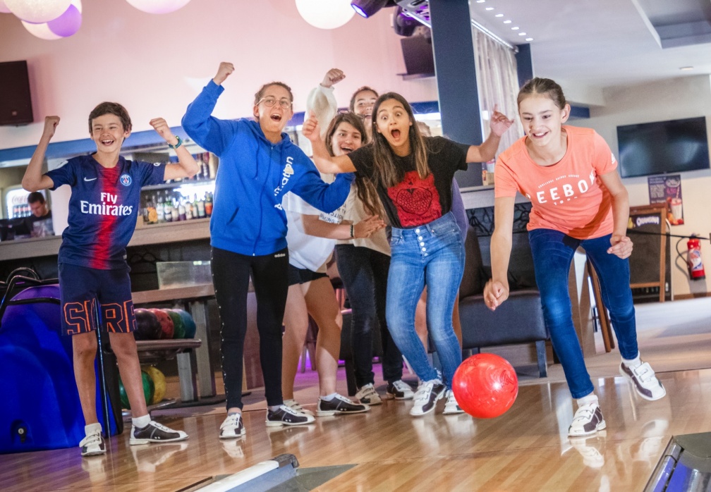 The teen club playing bowling