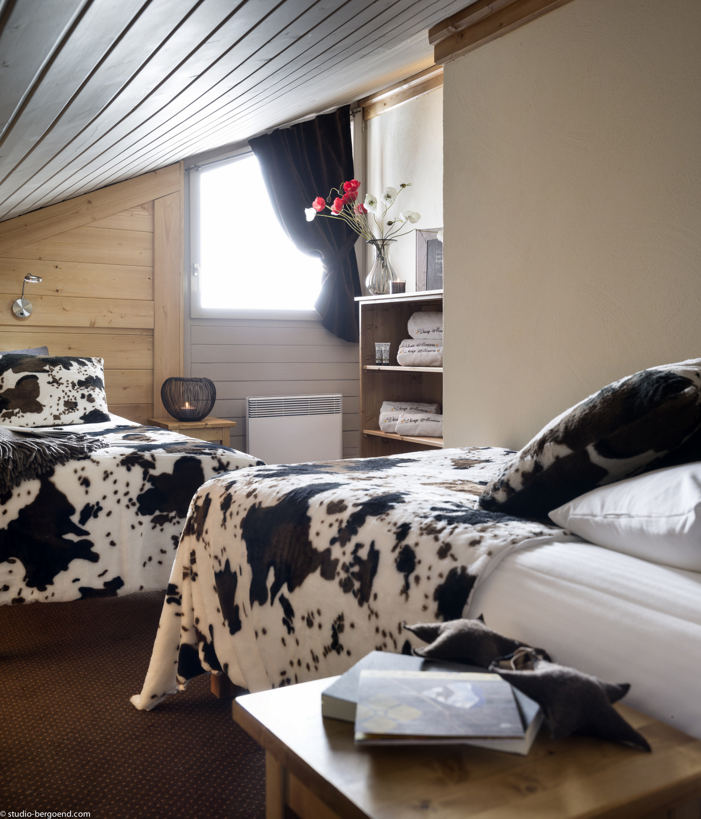 twin bedroom with cow print blanket