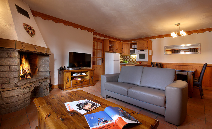An image of the living area with fireplace at Chalets des Neiges Plein Sud Val Thorens