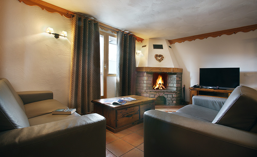 An image of the fireplace in one of the apartments at An image of a bedroom at Chalets des Neiges Plein Sud Val Thorens
