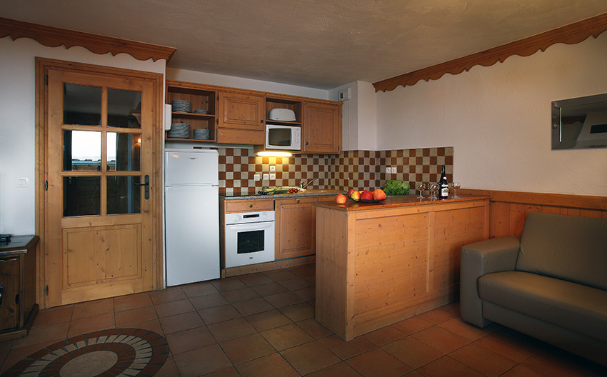 An image of one of the kitchens at An image of a bedroom at Chalets des Neiges Plein Sud Val Thorens