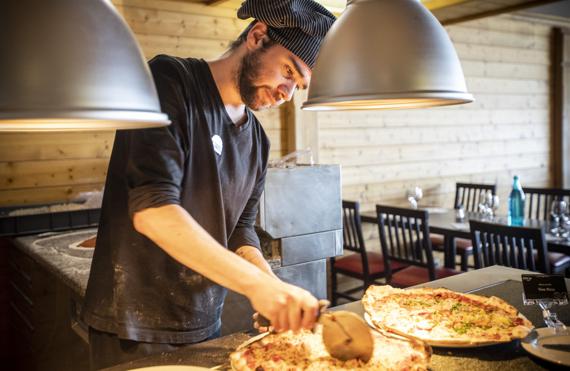 An image of a chef cooking pizzas for the buffet