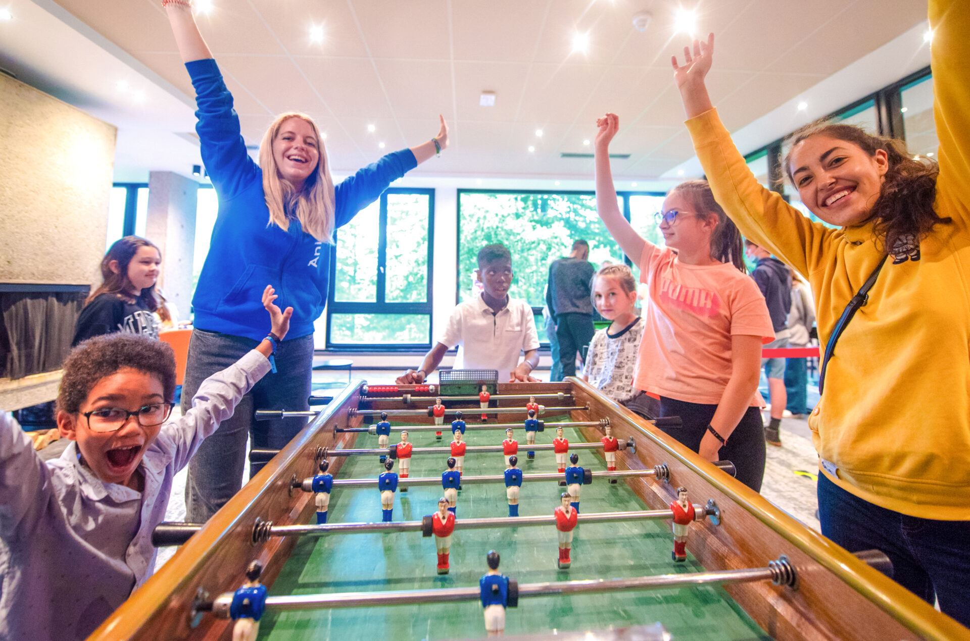 An image of a family playing on the table football table