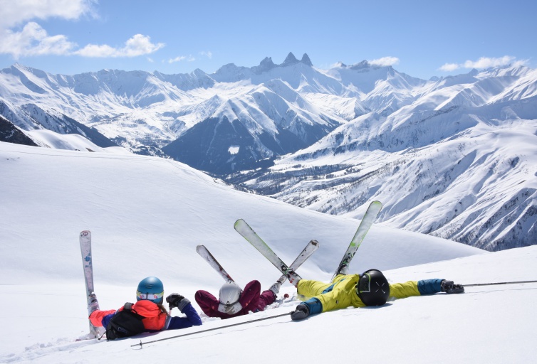 An image of people relaxing on the snow in Le Corbier
