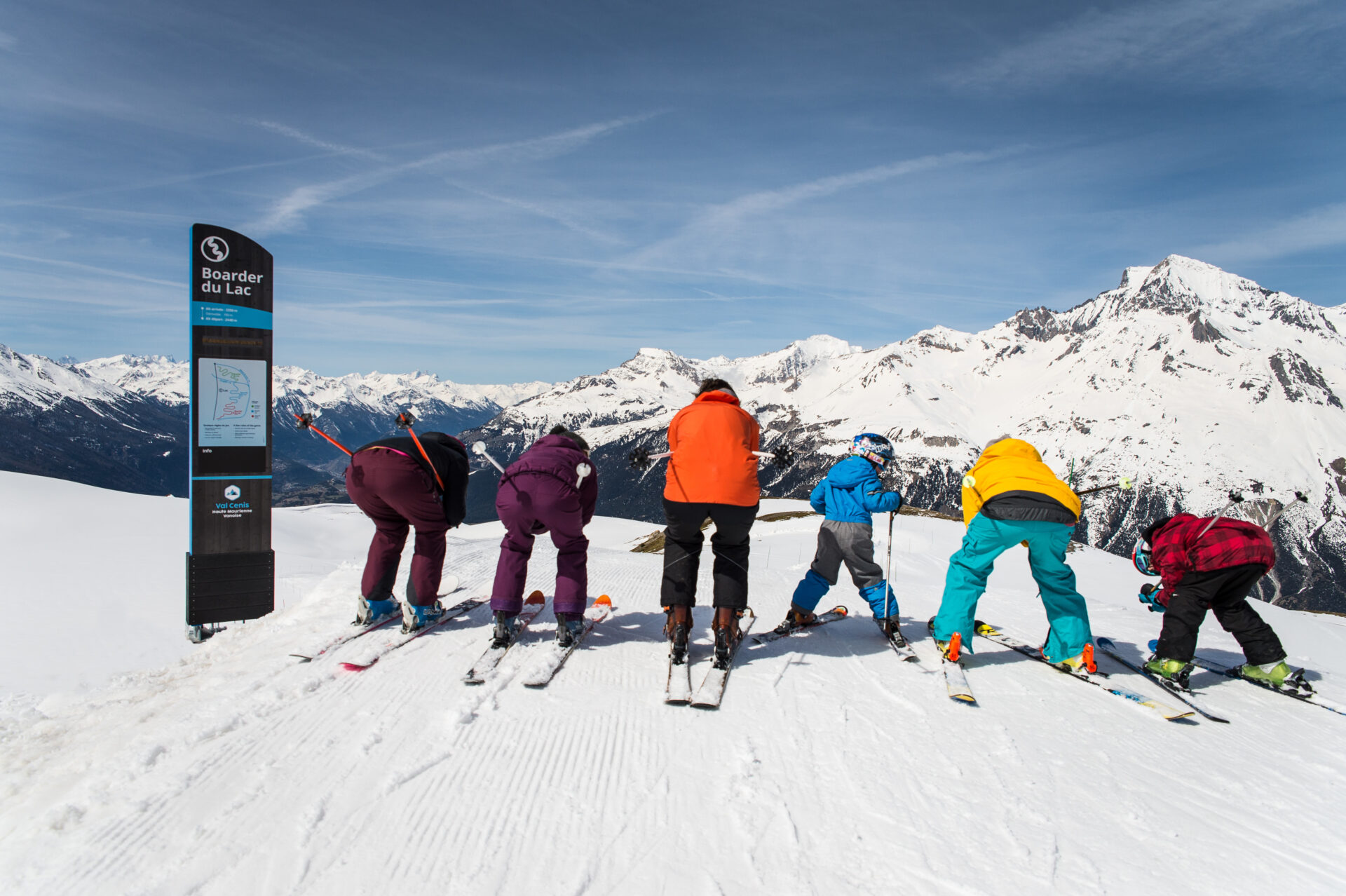 A group of skiers going down the pistes