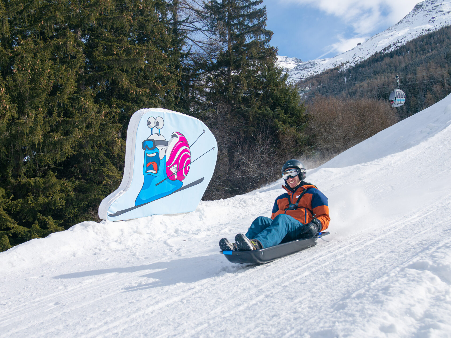 A man enjoying sledding in Val Cenis
